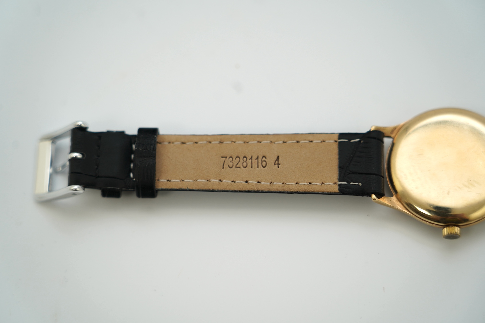 A gentleman's 9ct gold Movado manual wind wrist watch, with baton and Arabic numerals, on associated leather strap, case diameter 32mm. Condition - poor